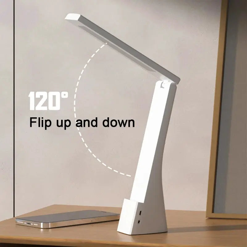 LED desk lamp with foldable white arm, 120° tilt; lamp and smartphone on desk