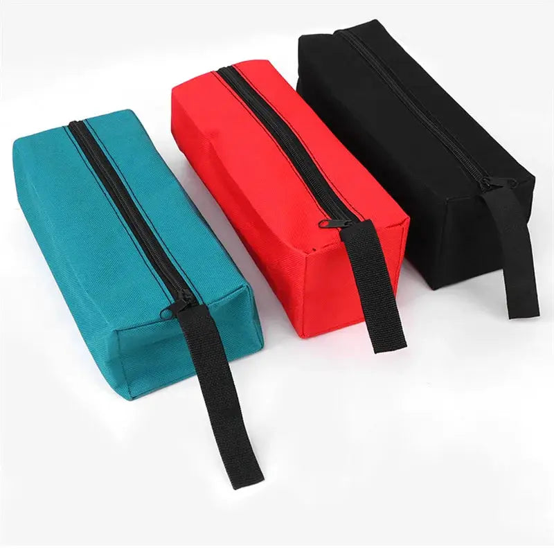 Small Oxford cloth hand-held tool bag set of three in teal, red and black with zipper closures