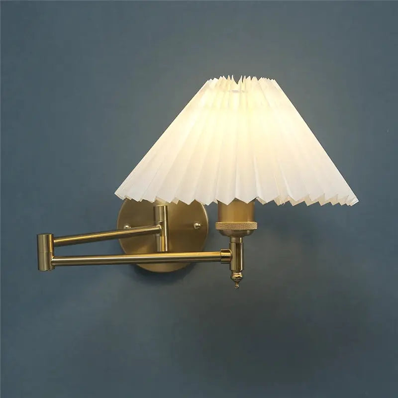 Nordic adjustable wall lamp with brass arm and white pleated shade by Simples Market.
