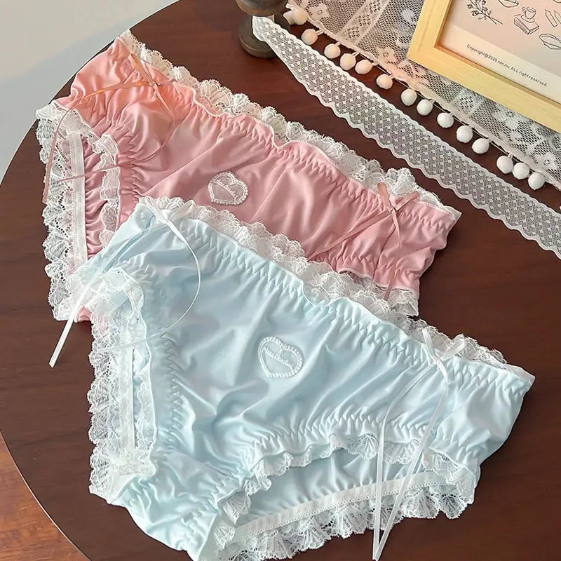 Plus-size satin lace panties set in pink and baby blue with heart embroidery and white lace trim.