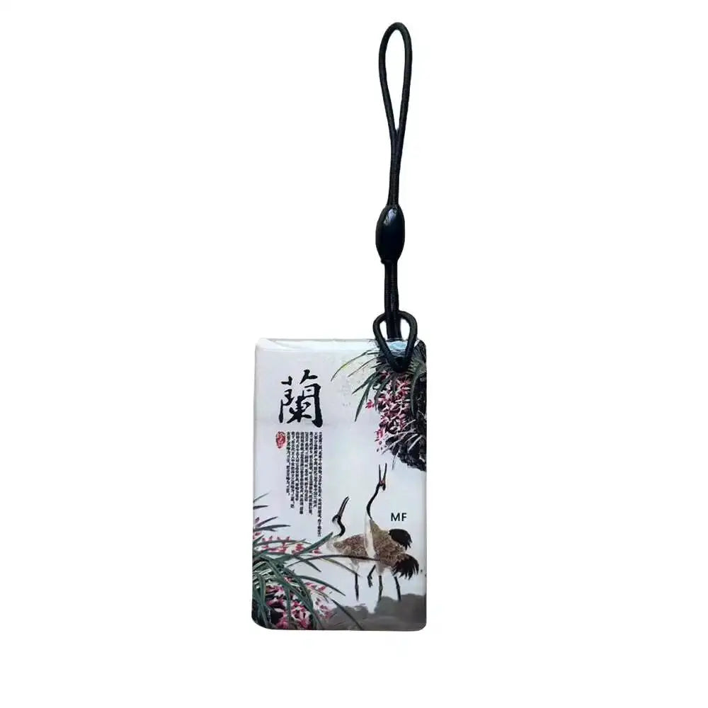 RFID key tag with black lanyard; white card featuring cranes and bamboo artwork.