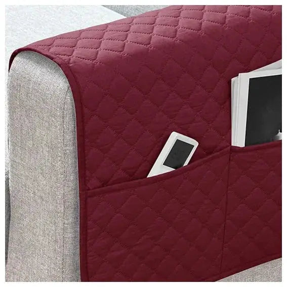 Sofa armrest cover with pockets in burgundy quilted fabric; water-repellent and roomy to hold remote and phone.