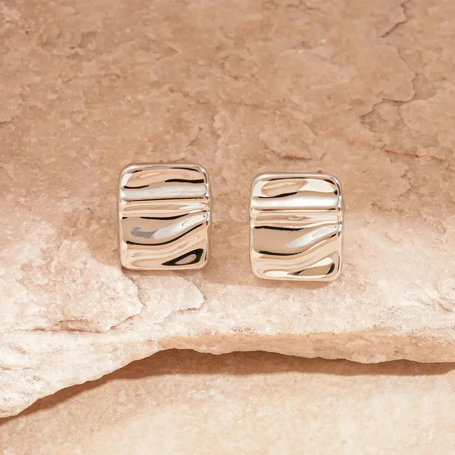 Earrings: pair of gold and silver-tone irregular pleated oval acrylic square studs by Simples Market