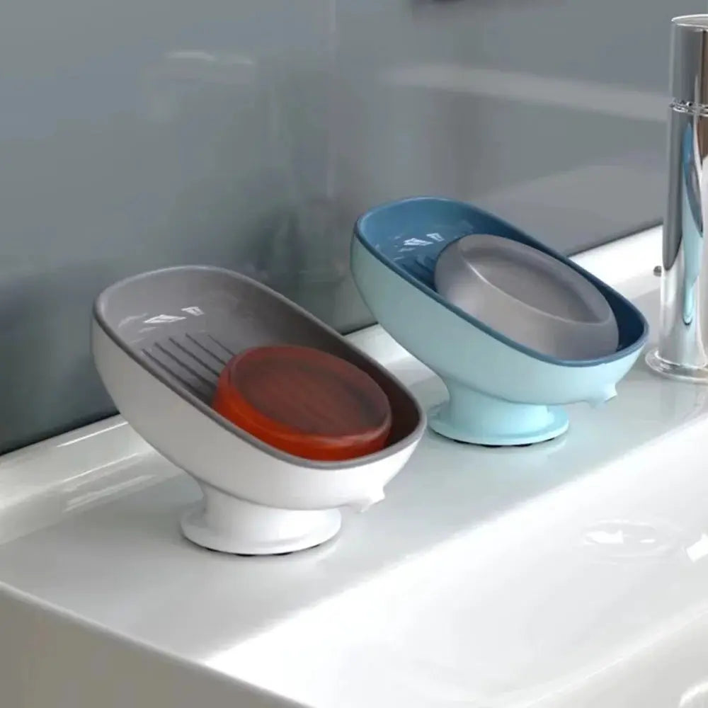 Two suction cup soap holders with drain, white and blue, for bathroom or kitchen counters
