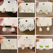 White dangle earrings assortment by Simples Market featuring floral, pearl, and bow designs