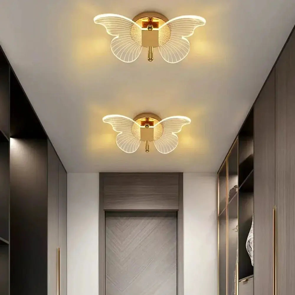 Pair of butterfly LED wall lamps by Simples Market, gold metal with acrylic wings, tri-color, 110–220V wired