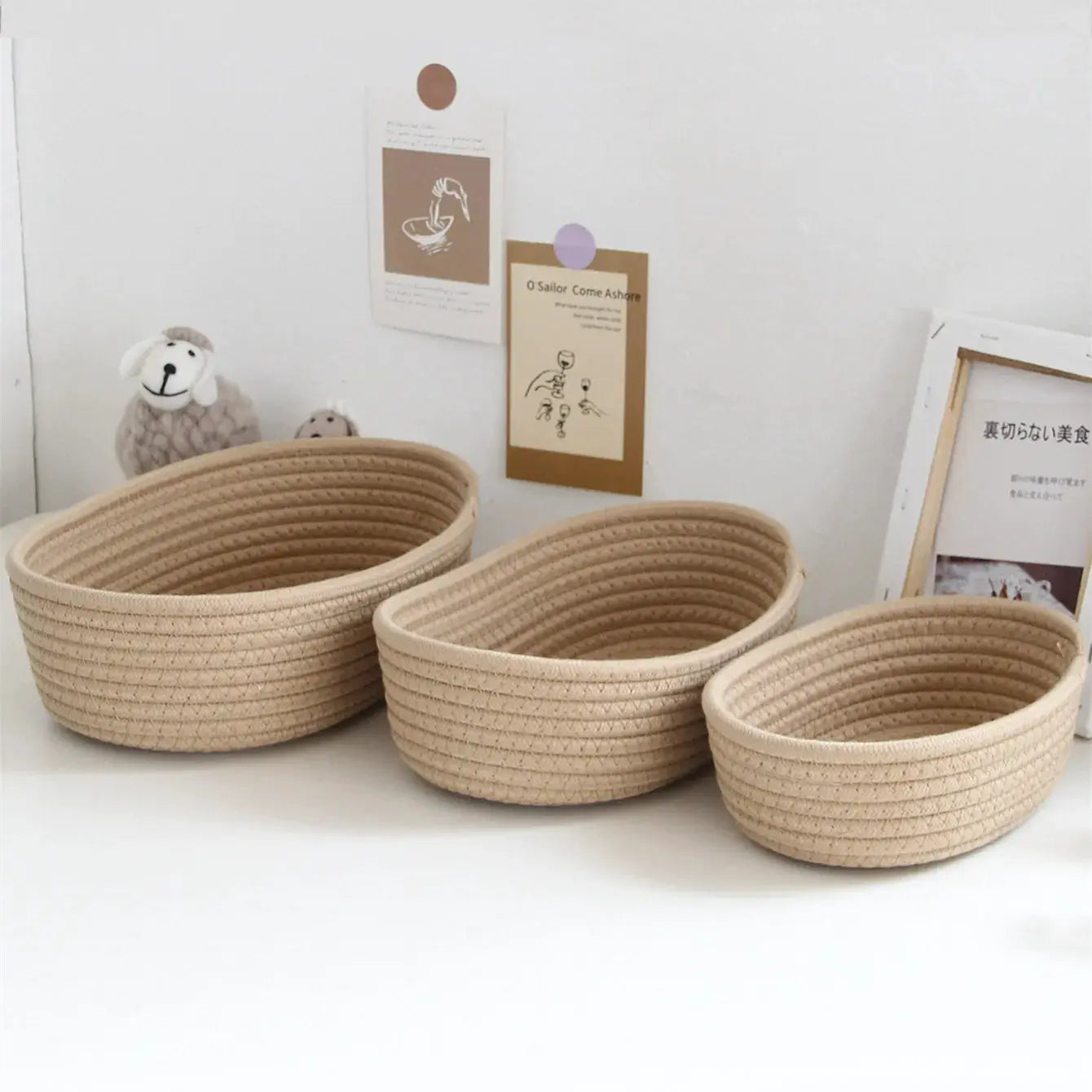 Three woven storage baskets in natural beige for desk organization, cosmetics and toys