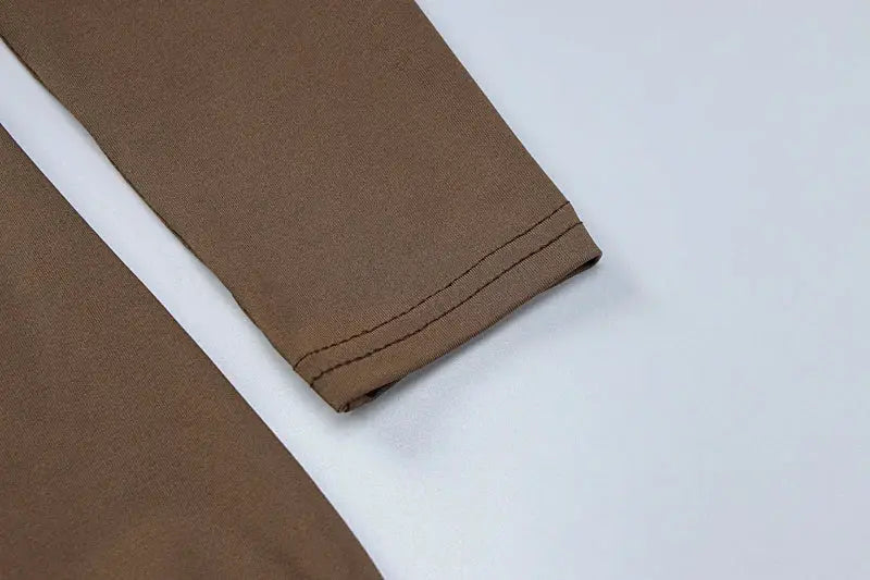 Hugcitar long-sleeve brown playsuit sleeve cuff close-up, solid fabric.