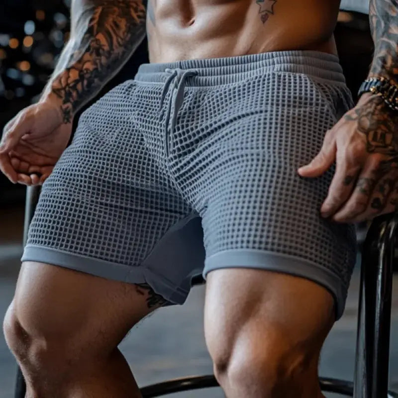 Men's oversized stretch waffle shorts, gray waffle-knit fabric with elastic waist and breathable quick-dry comfort.
