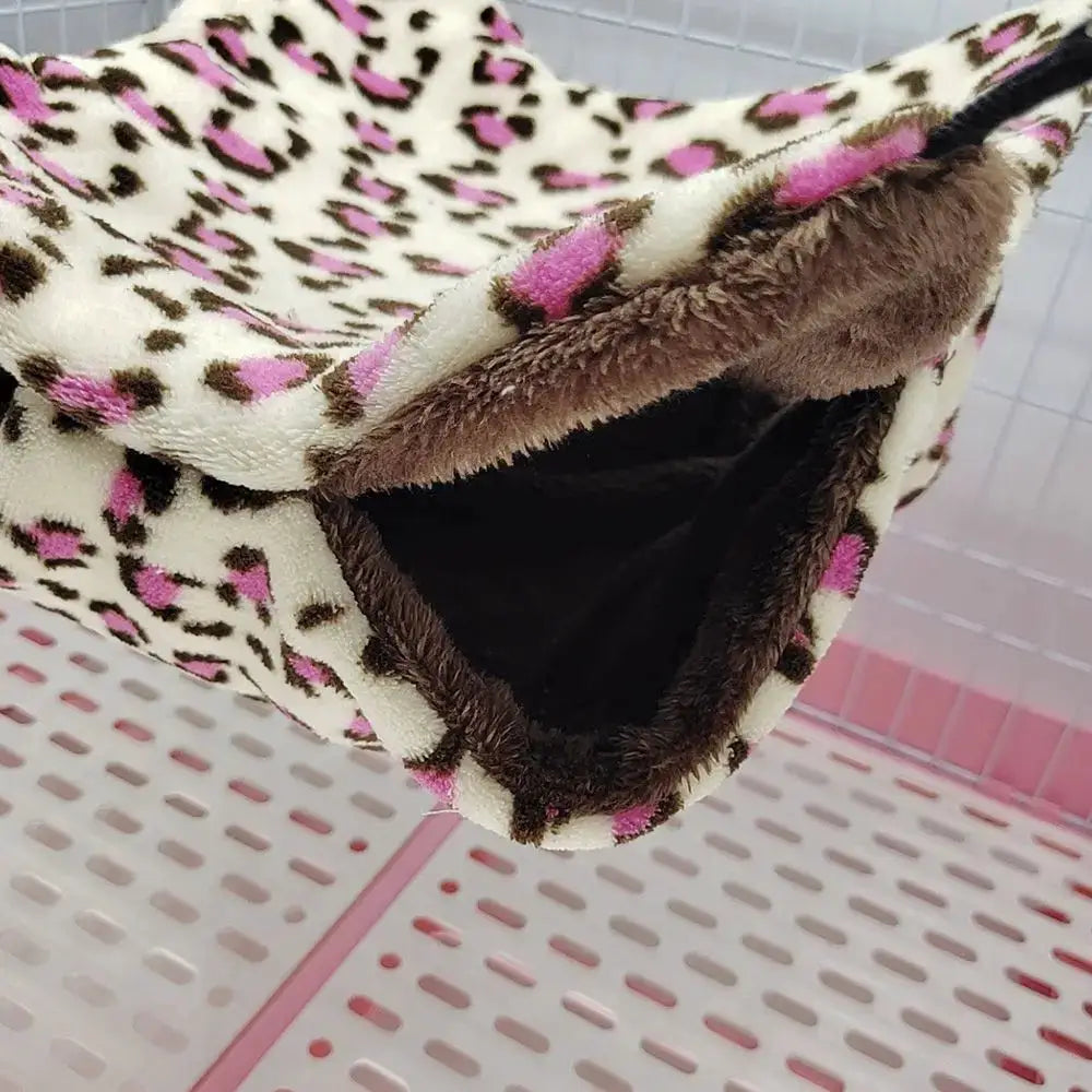 Warm plush hamster hammock with pink leopard print exterior and brown lining, double-layer sleeping bag nest