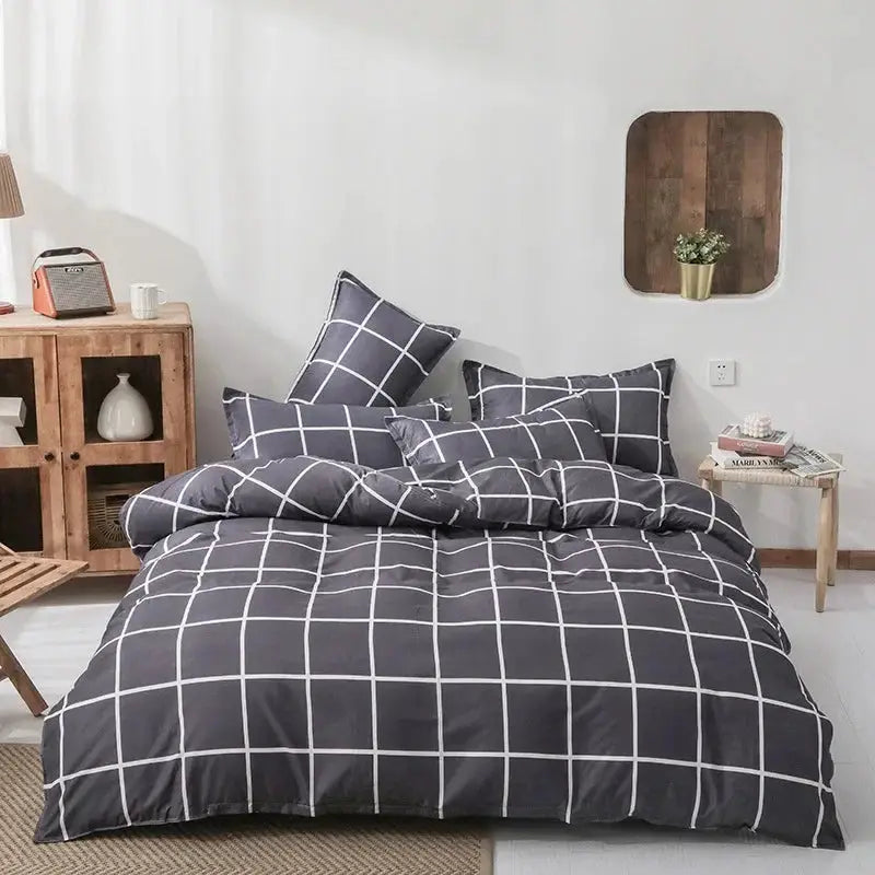 Dark gray cotton bedding four-piece set with white grid-pattern duvet cover and matching pillowcases on a bed
