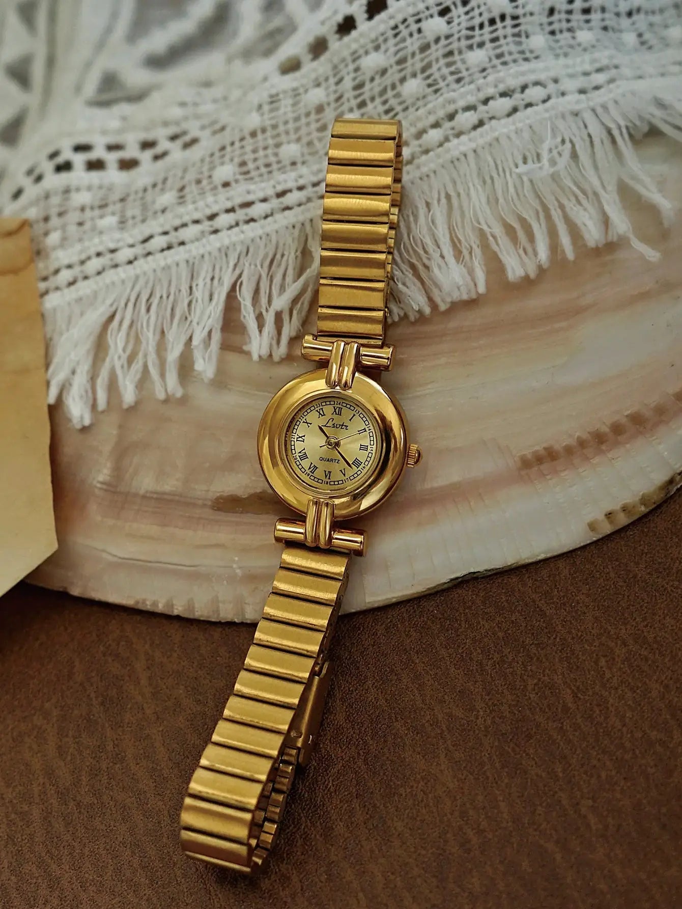Simples Market gold-tone women's wristwatch with a small Roman numeral dial and linked bracelet.