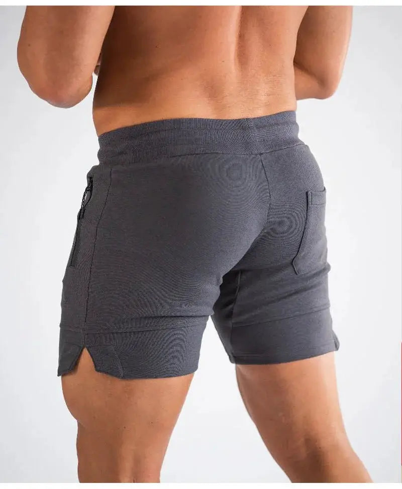 Men's gray zip-pocket athletic shorts by Simples Market, elastic waistband, back view.