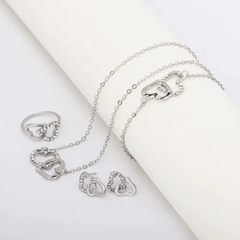 Five-piece silver-tone heart-shaped rhinestone jewelry set for women with rings, earrings, necklace, and bracelet