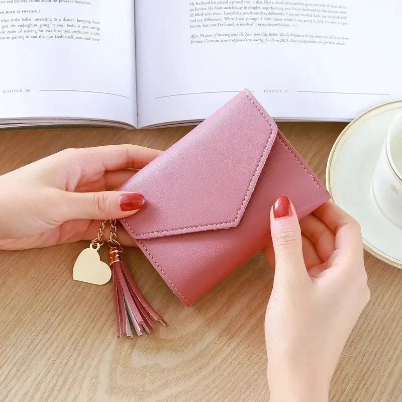 Pink PU leather women's wallet with tassel keychain, compact card holder and coin purse.