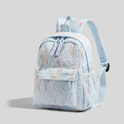 Simples Market women's mini backpack in light blue quilted fabric with pastel embroidery, zipper closure, adjustable straps