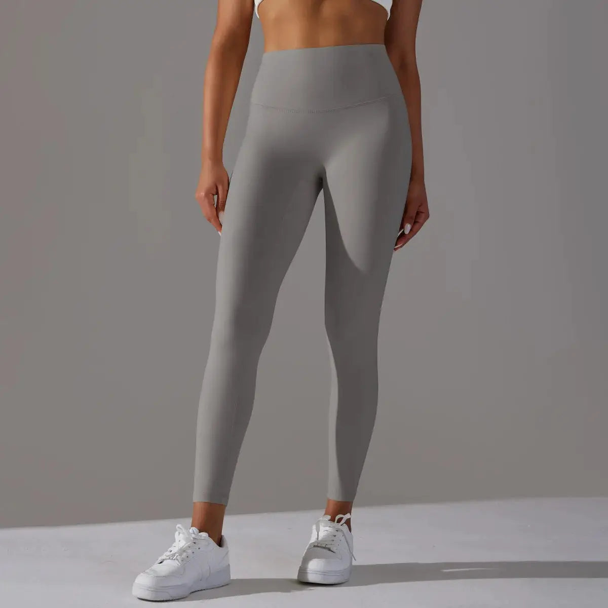 Women's high-waist gray leggings for fitness and yoga; form-fitting gym pants