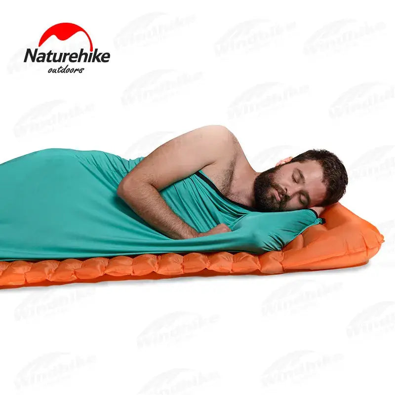 Sleeping bag liner by Naturehike in turquoise, ultralight portable travel sheet with orange pad