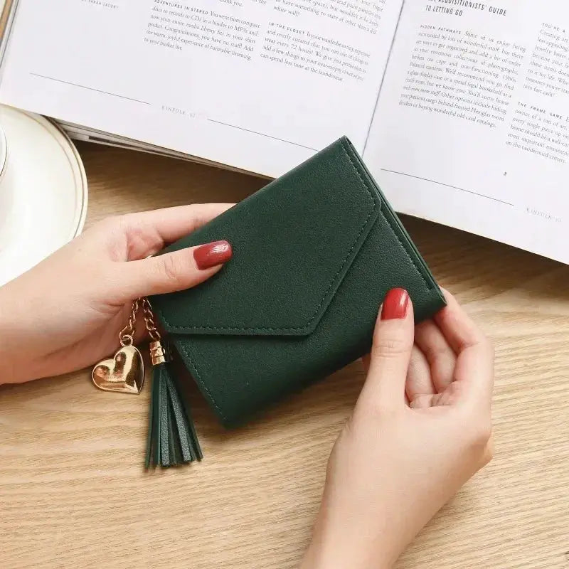 PU leather women's short wallet by Simples Market in green with hasp, tassel and heart charm