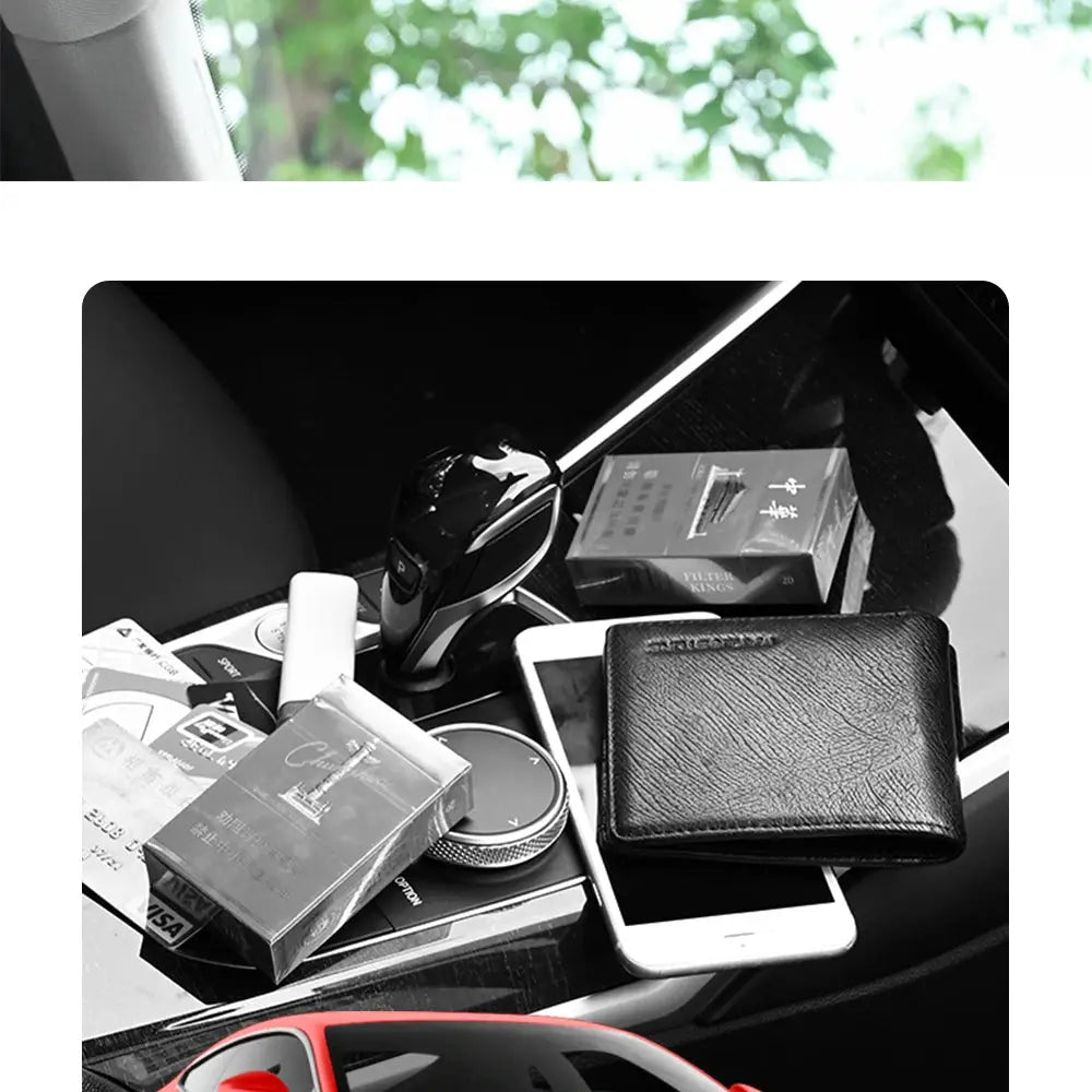 Car sun visor organizer in black with sunglasses clip; visible wallet and smartphone on the console