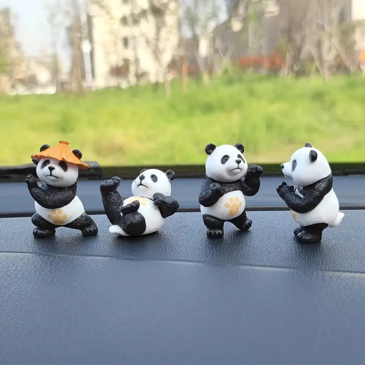 4-piece panda car ornament set; white and black panda figurines for car interior decor, one with an orange hat.