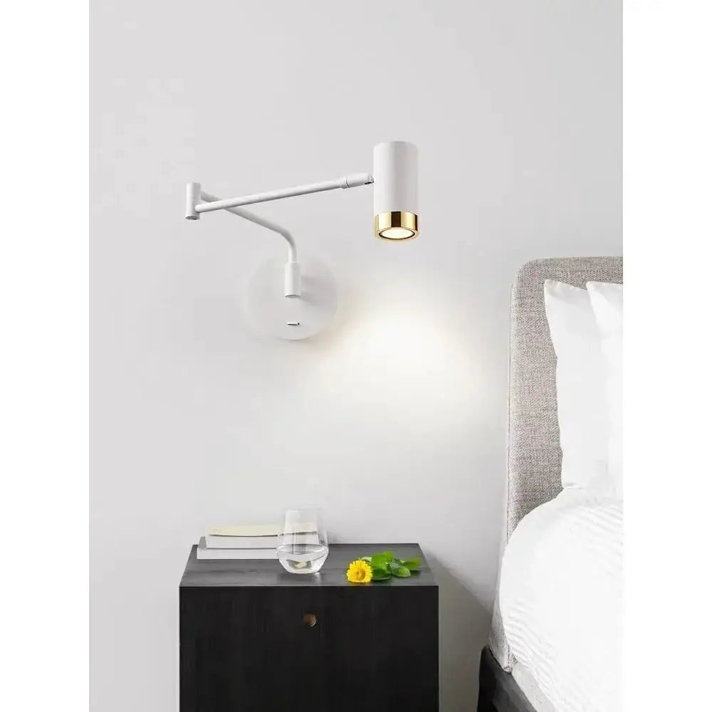 White wall-mounted reading lamp with telescopic arm and gold accent for bedside lighting