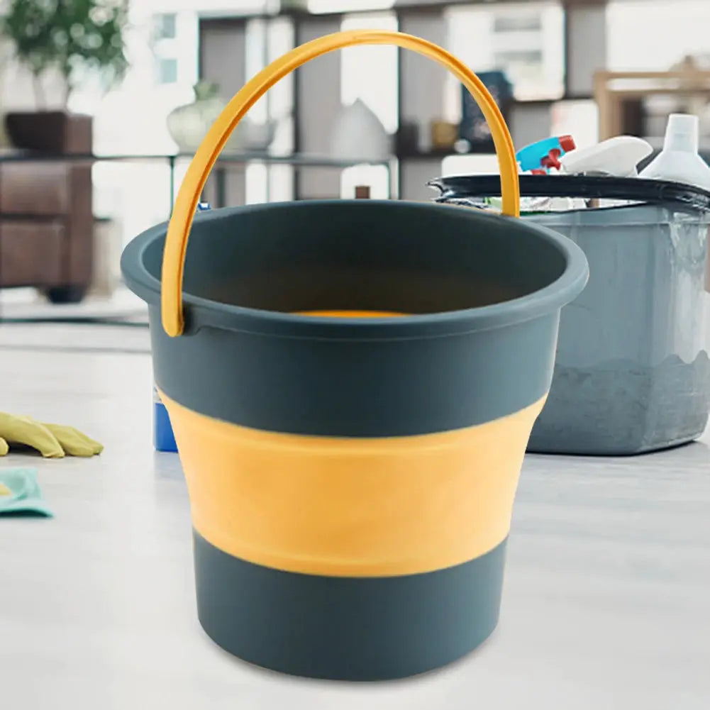 Folding silicone bucket with cover, teal body with yellow band and handle; Simples Market.