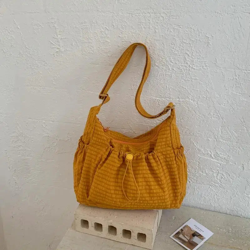 Korean nylon shoulder bag in mustard plaid with drawstring closure and crossbody strap