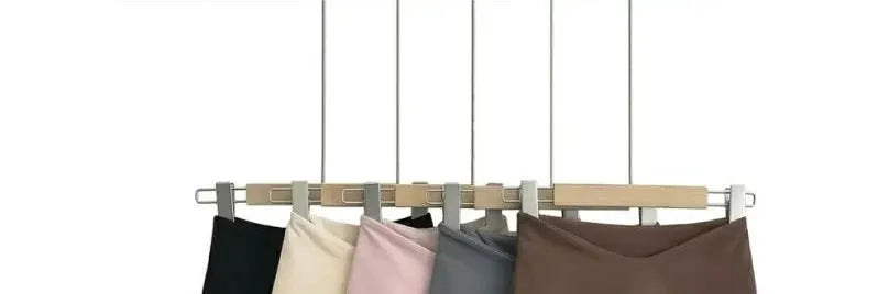 Women’s A-line mini skirts by Simples Market in black, beige, pink, gray, and brown on a hanging rack (six pieces)