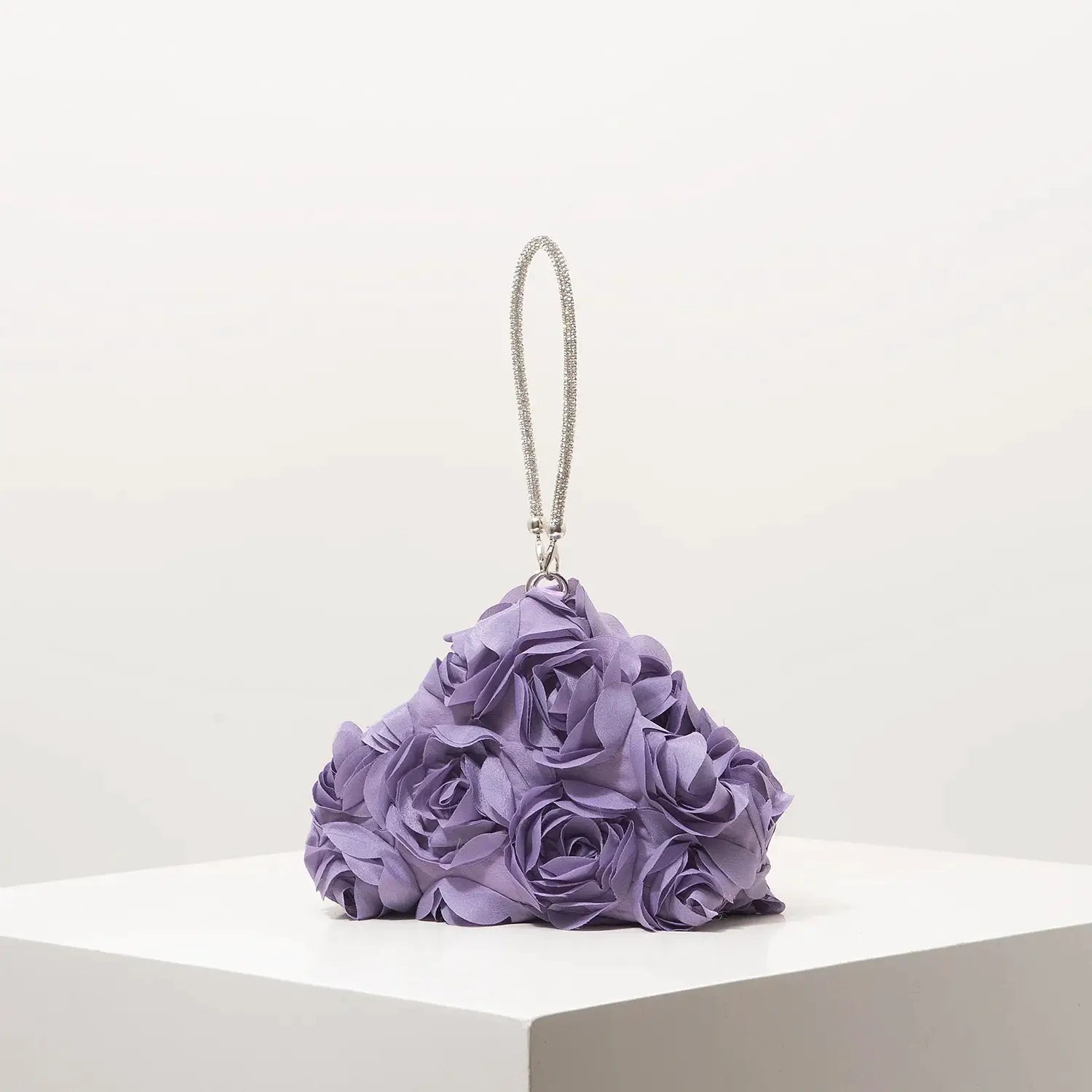 Mini purse with purple floral pom-pom design and a silver chain strap