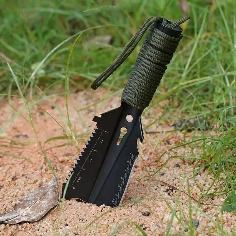 Outdoor sappers shovel by Simples Market; black stainless steel, paracord-wrapped handle.