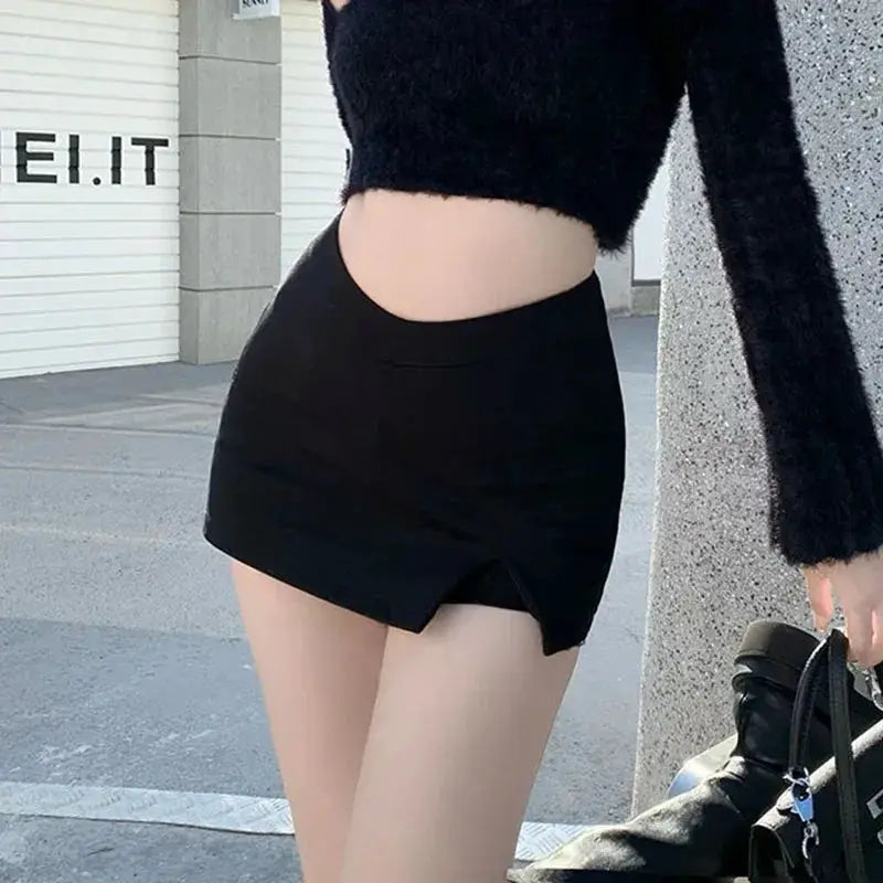 Black high-waist split mini skirt with a front slit, shown with a cropped fuzzy top