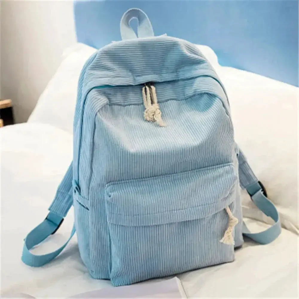 Light blue corduroy student backpack with front pocket and rope tassels