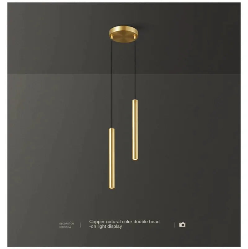 Minimalist bedside LED pendant lamp with dual gold cylindrical pendants on black cords