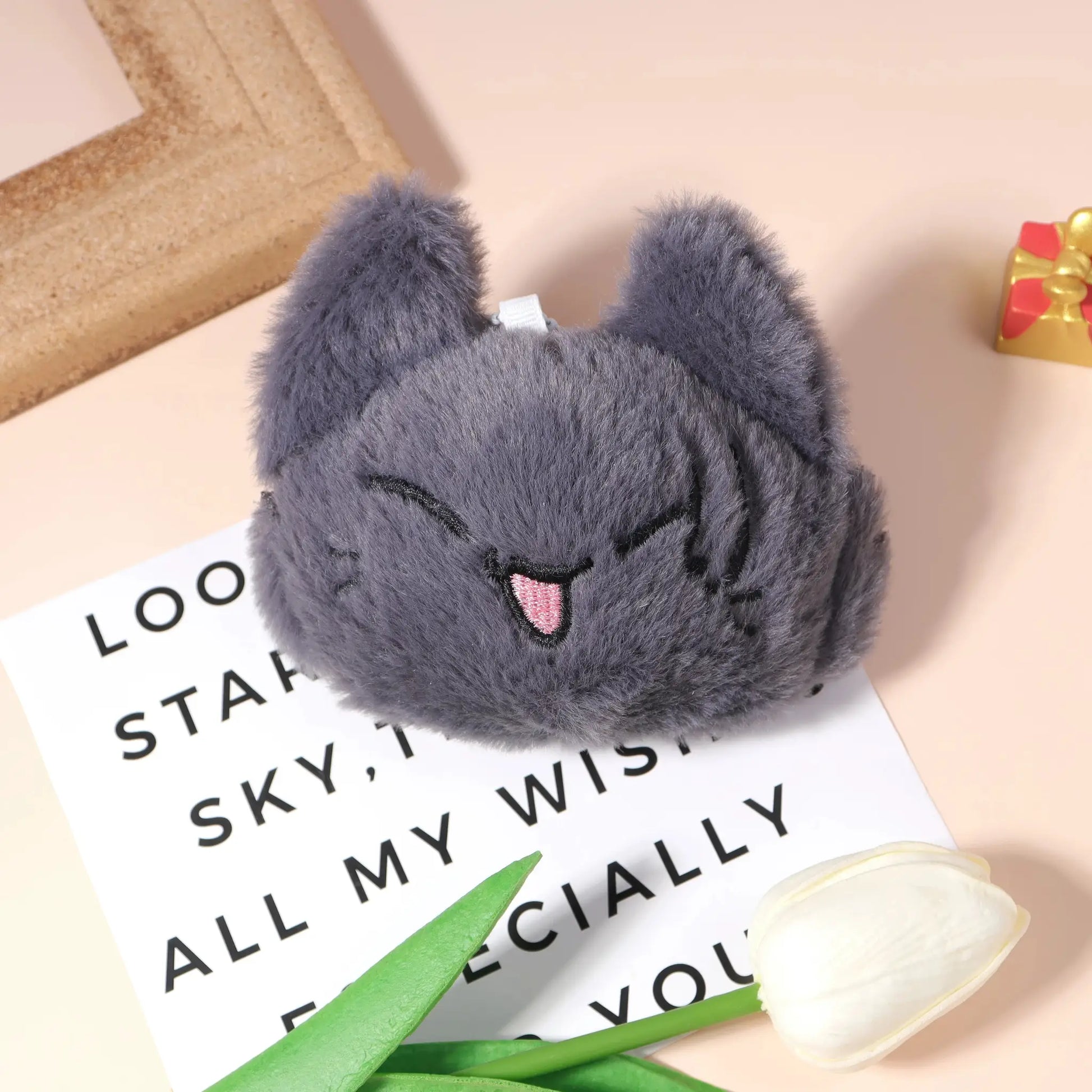 Plush keychain pendant; gray fluffy fur with ear-shaped contours and blue loop