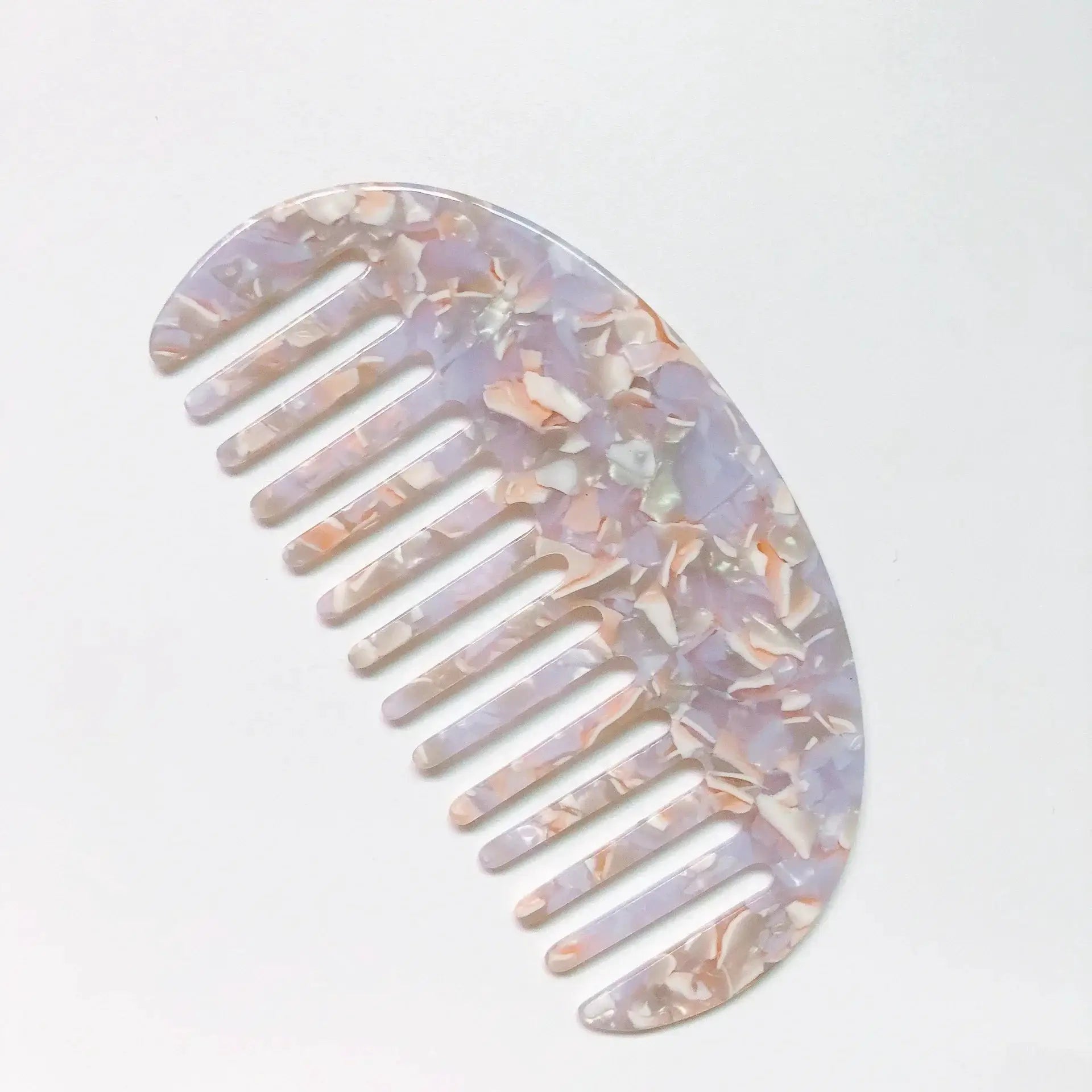 Wide-teeth acetate hair comb with pastel marbled pattern; anti-static styling accessory