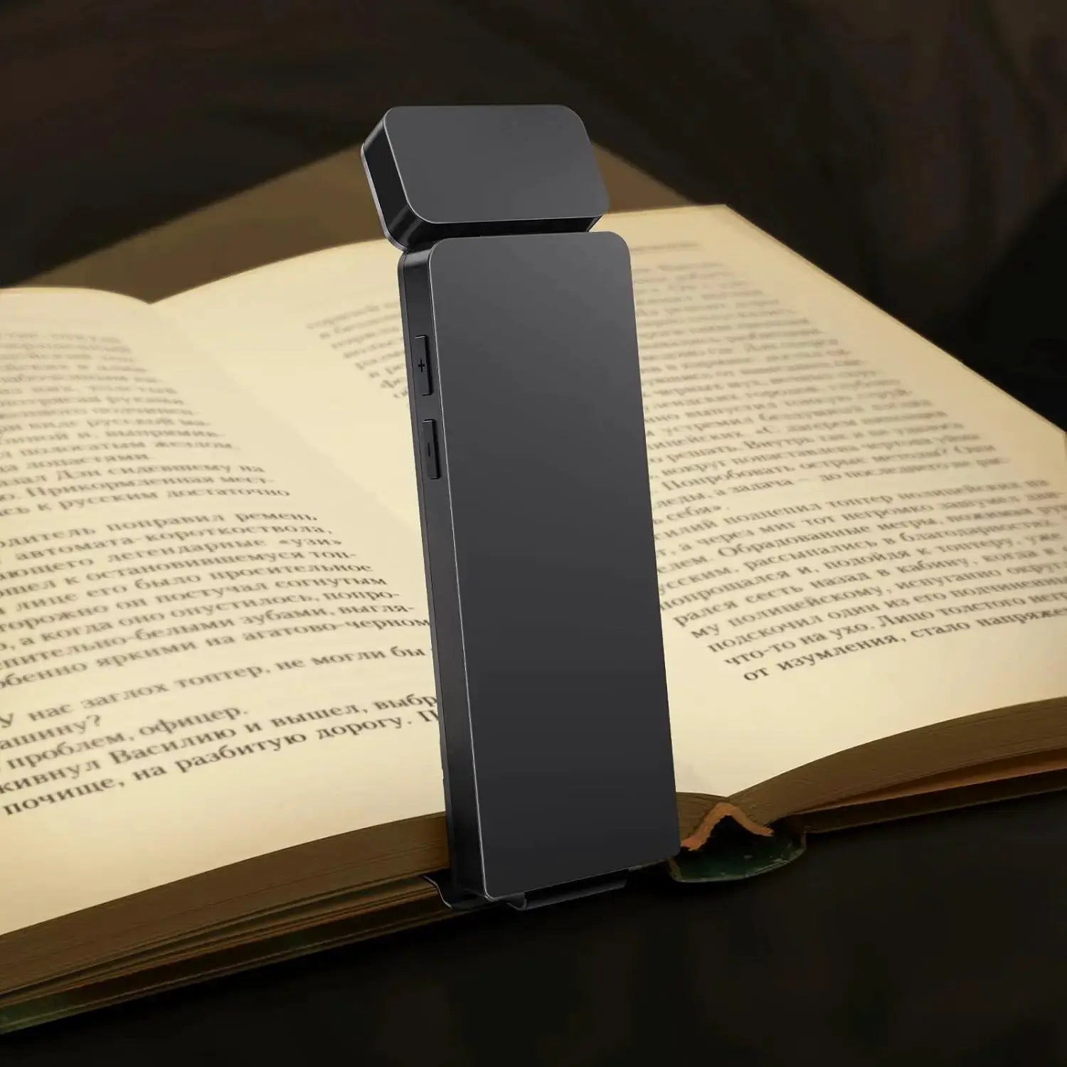 Simples Market LED rechargeable clip-on book light in black, 3 colors, 5 brightness levels, clipped to an open book.