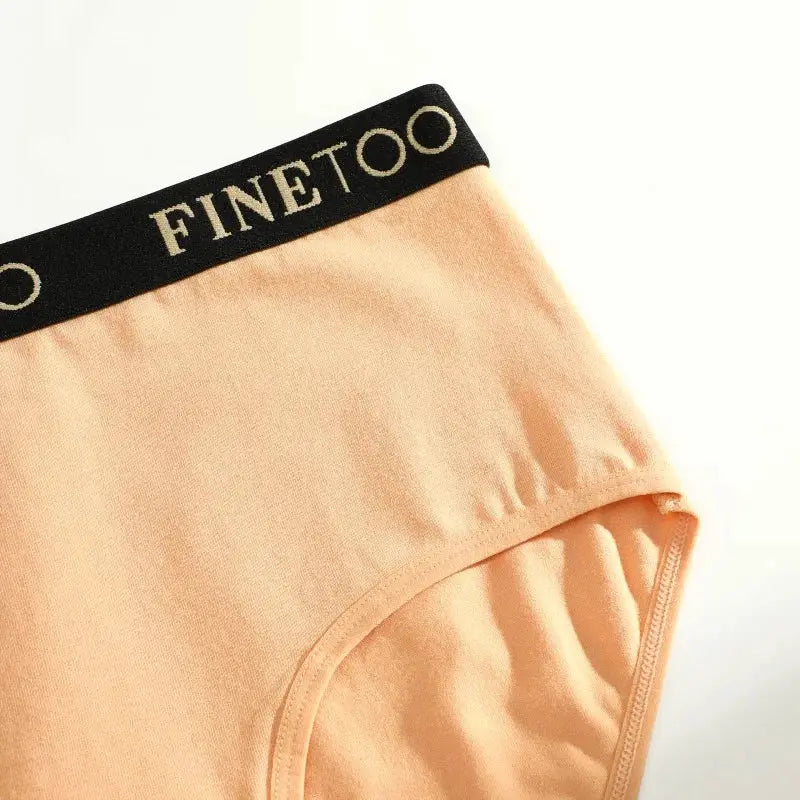Finetoo women's seamless cotton briefs in peach with black logo waistband, low-rise
