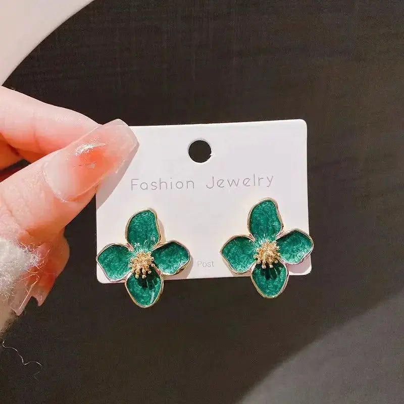 Pair of green enamel four-petal flower stud earrings with gold-tone edges