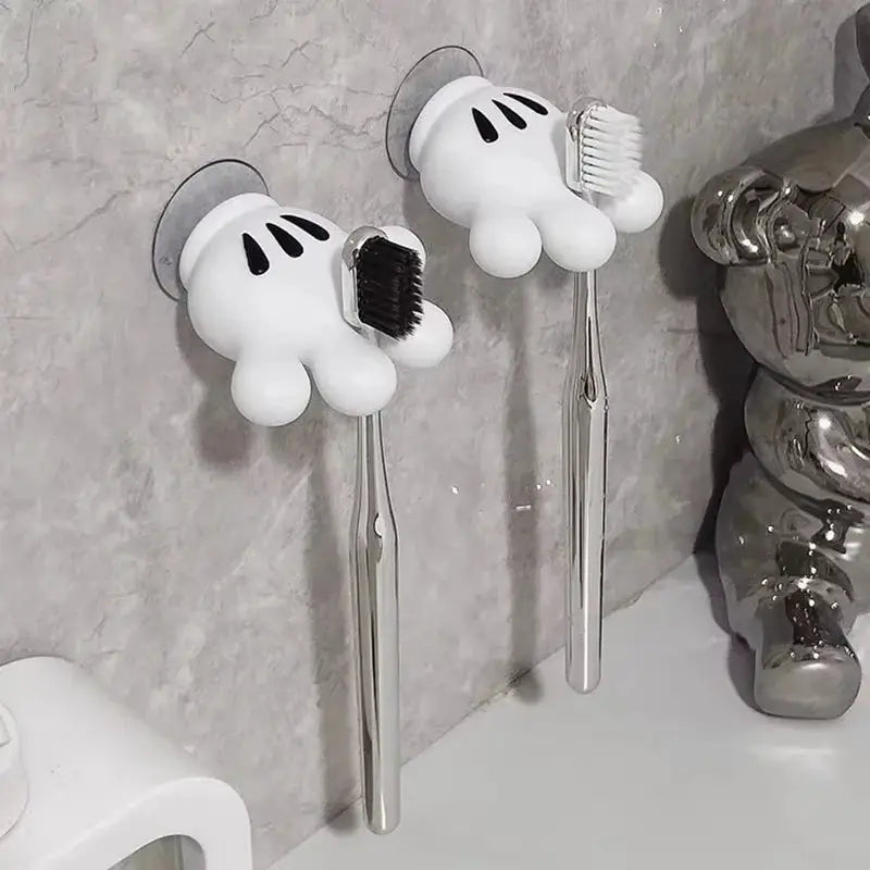 Toothbrush holder Mickey Palm pair with suction cups; white cartoon-hand hooks hold brushes on bathroom wall