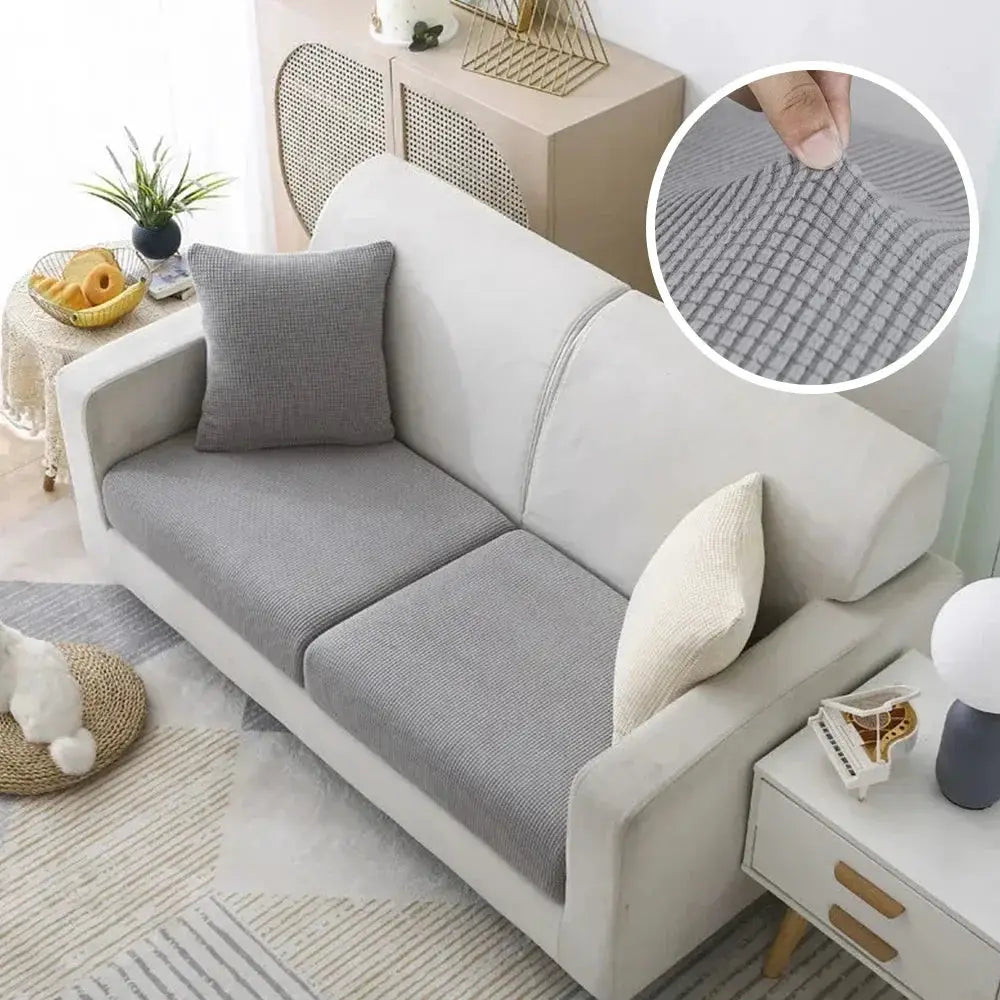 Jacquard Pure Sofa Covers by Simples Market in gray polar fleece on a beige sofa; removable stretch couch protector