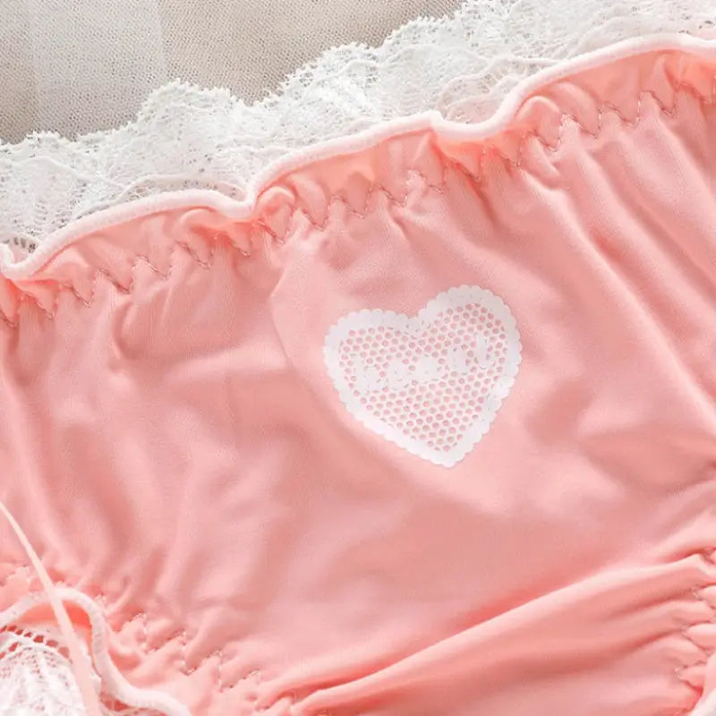 Pink satin panties with lace trim and white heart appliqué, low-rise breathable underwear.