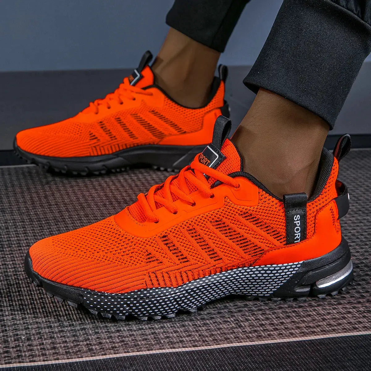 Pair of men's running shoes by Simples Market, bright orange breathable mesh upper with lace-up and non-slip sole