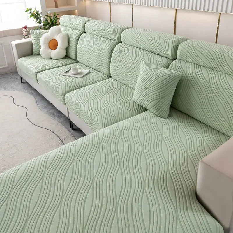 Elastic sofa cover by Simples Market; mint green with a wavy textured pattern for pet-friendly living room protection