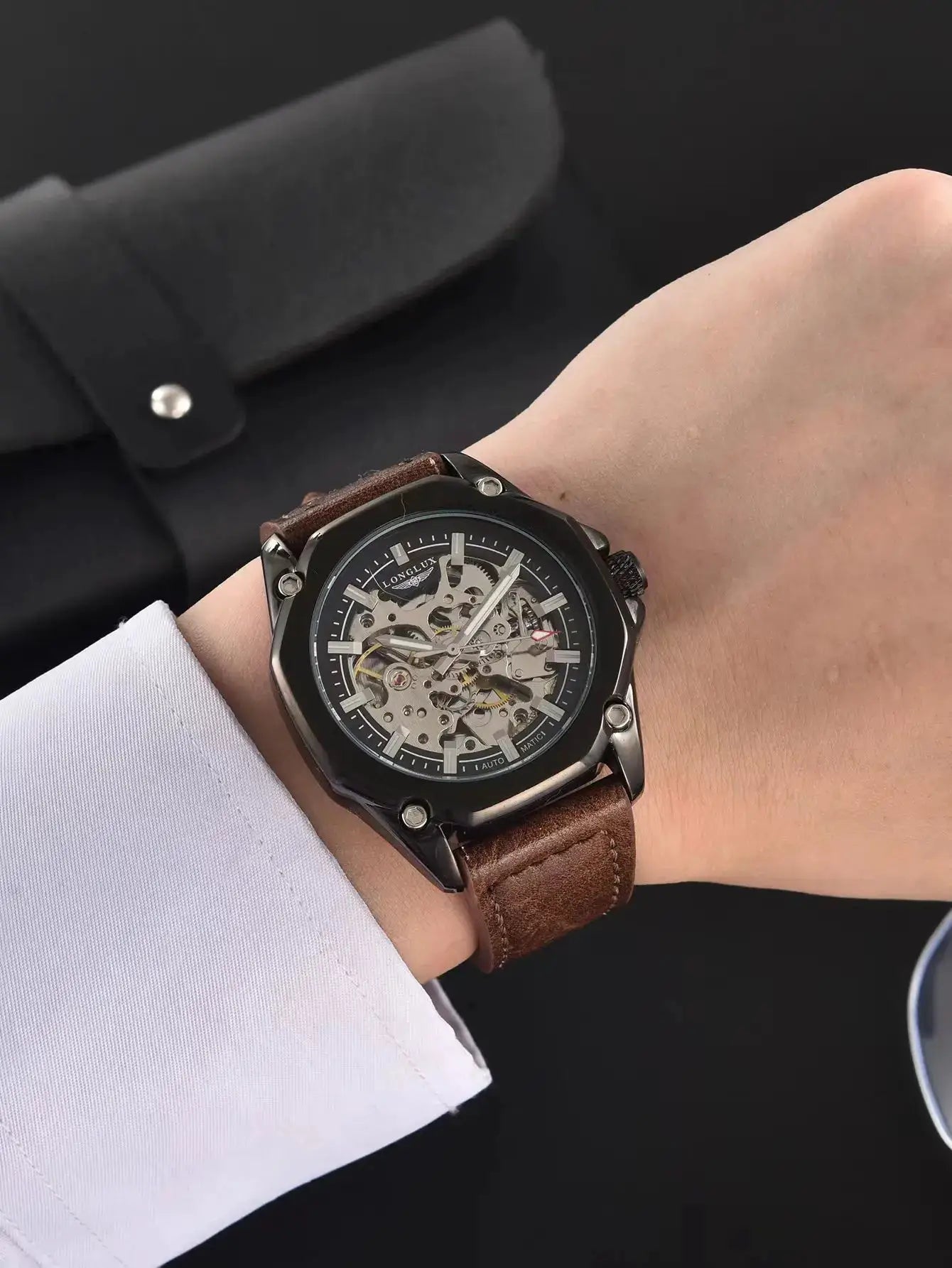 Men's skeleton automatic wristwatch with visible gears, black case, brown leather strap