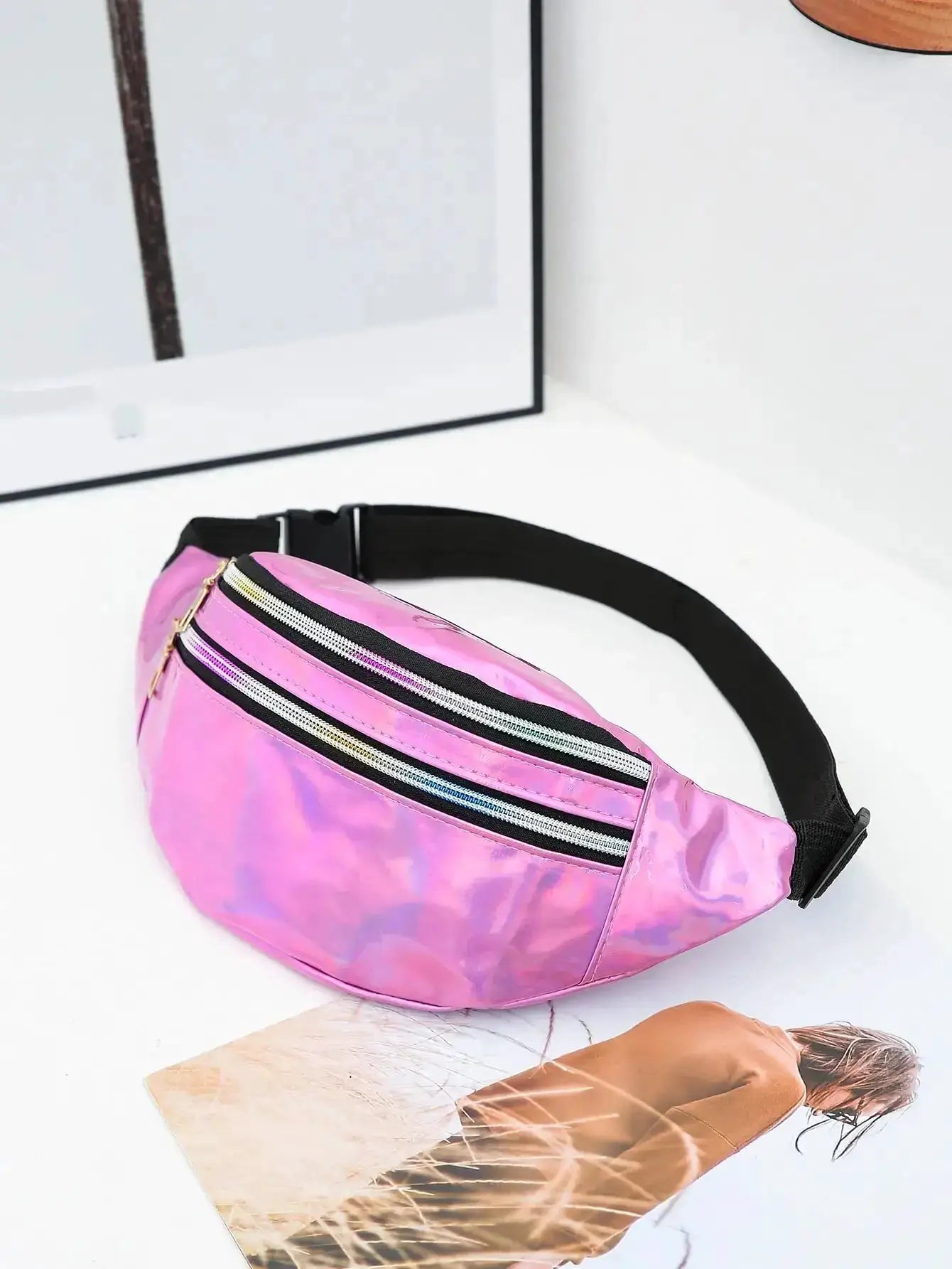 Holographic pink waist bag with black adjustable strap and dual zippers
