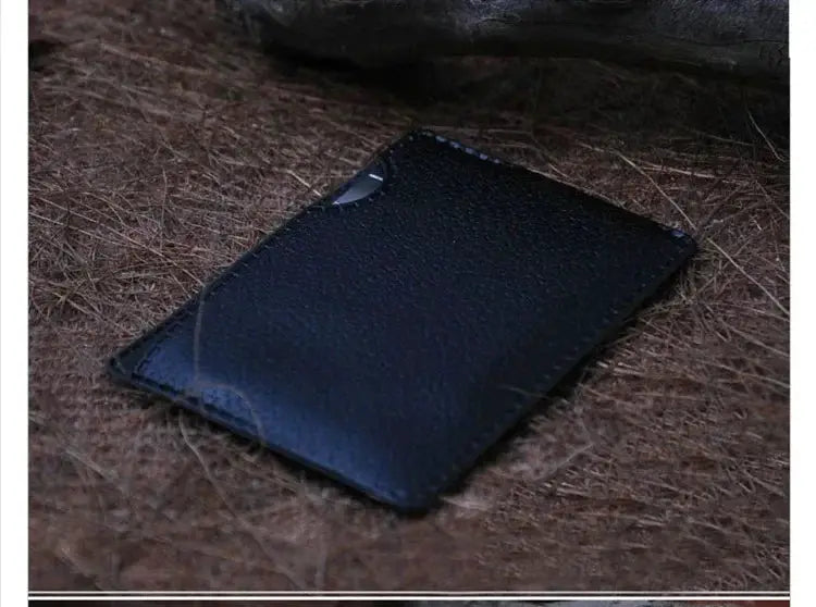 Simples Market black leather wallet card holder on brown textured surface