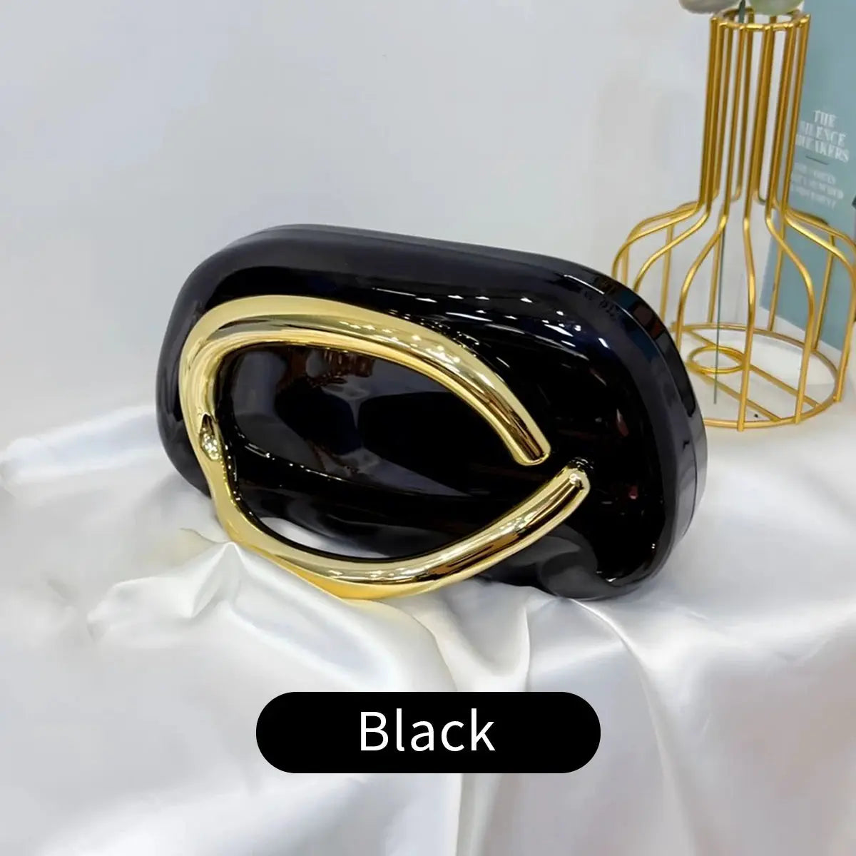 Simples Market acrylic box crossbody bag, black with gold curved hardware, evening clutch.
