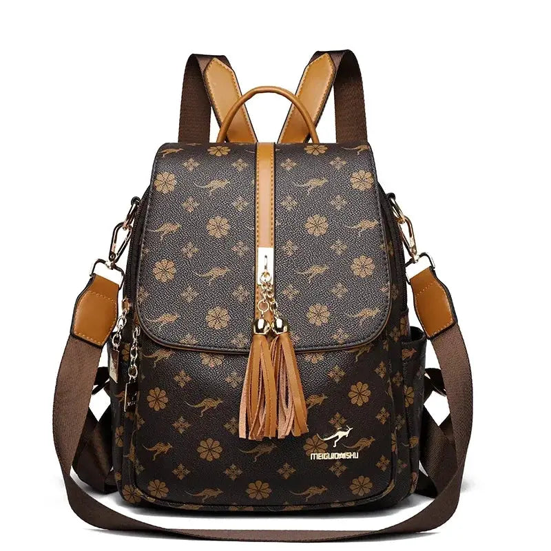 Ladies backpack by Simples Market in brown leather with floral print and tassel charms.