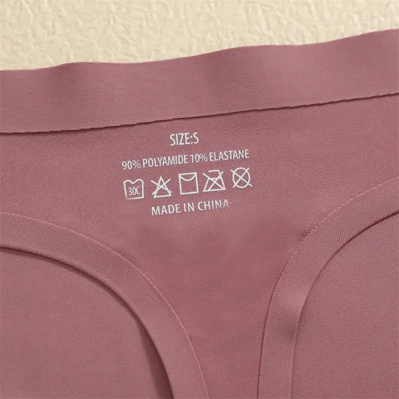 Pink seamless women's underwear with care label showing 90% polyamide 10% elastane